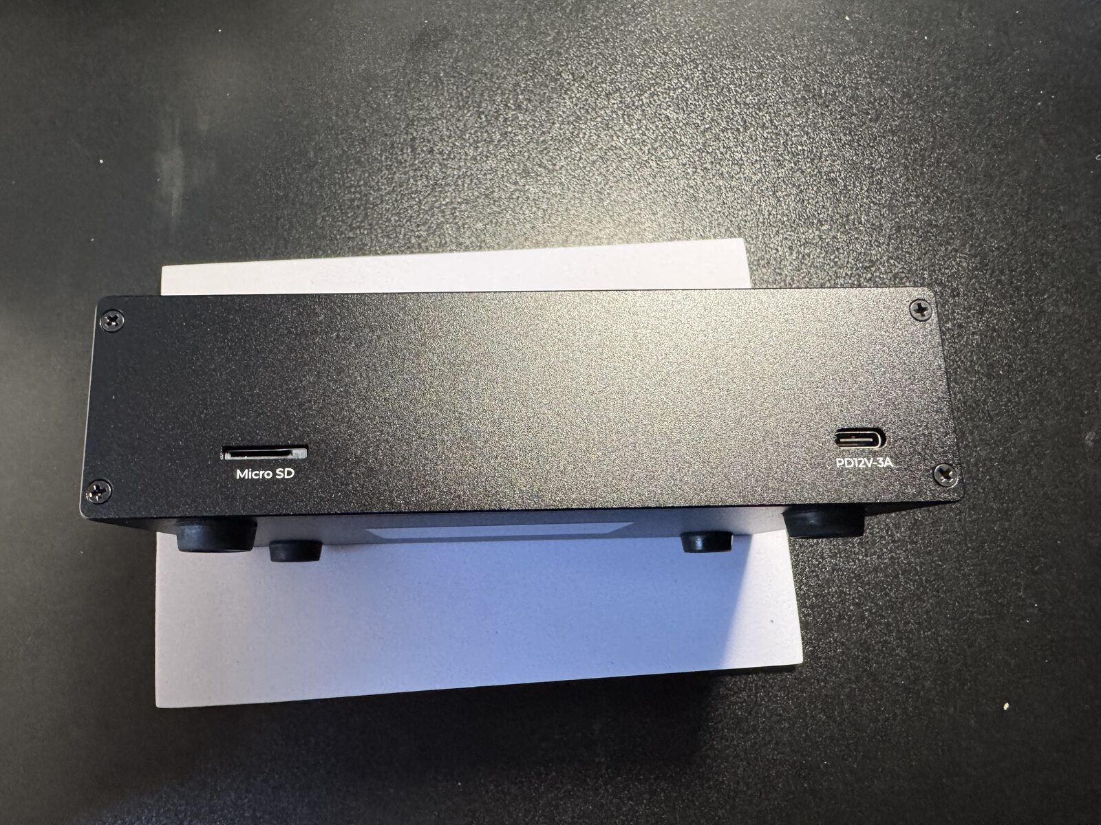 The four screws on the front of the router