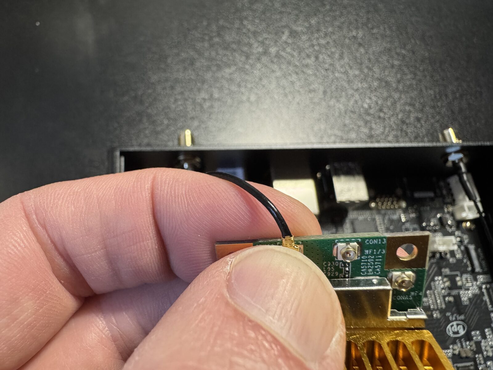 Pressing an antenna connector onto the module with a fingertip