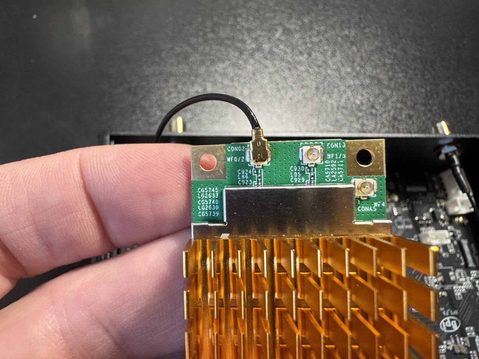 An antenna connector seated flat on the module's socket